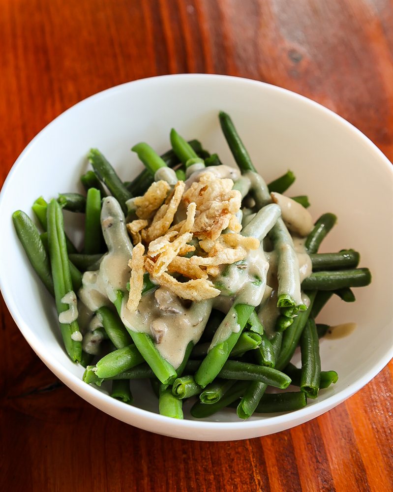 Vegan green bean casserole topped with crispy fried onions